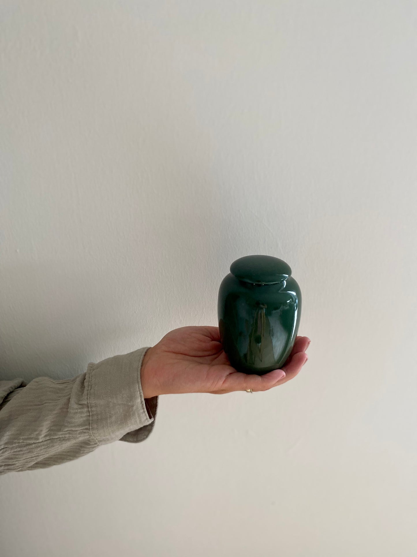 kleine groene urn keramiek voor mens en dier in hand